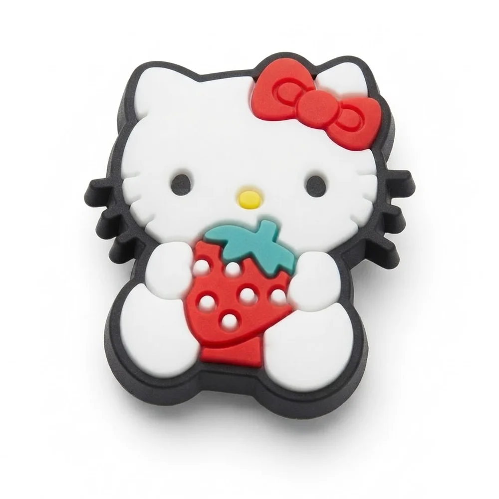 Jibbitz Hello Kitty tenant une fraise rouge, épais contour noir et nœud rouge