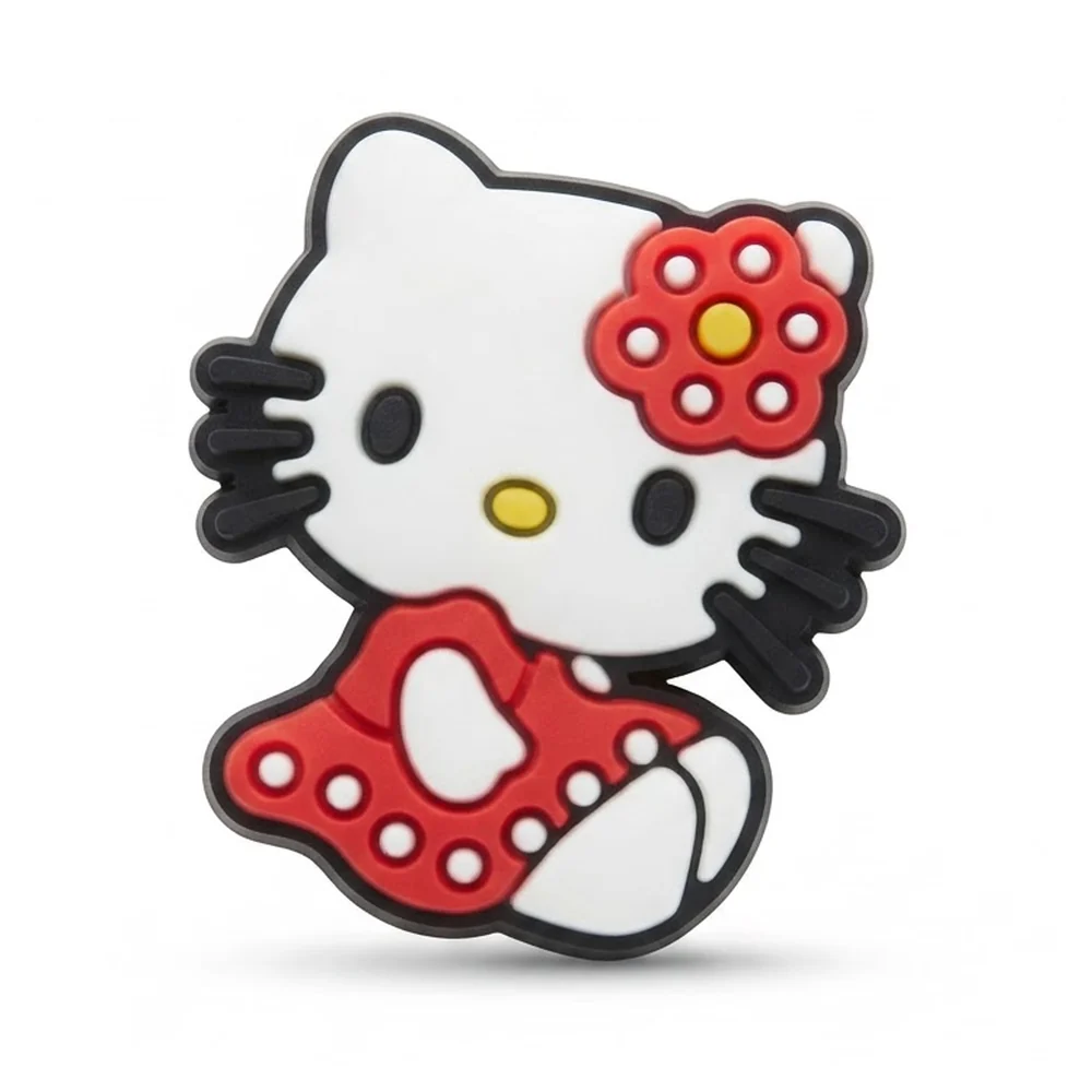 Jibbitz Hello Kitty assise, robe rouge à pois blancs et fleur rouge à cœur jaune