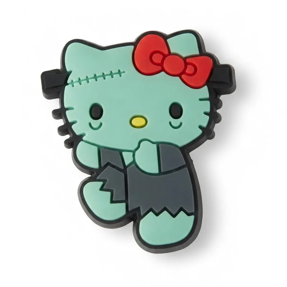 Jibbitz Hello Kitty Frankenstein : visage vert menthe à coutures, frange noire, nœud rouge