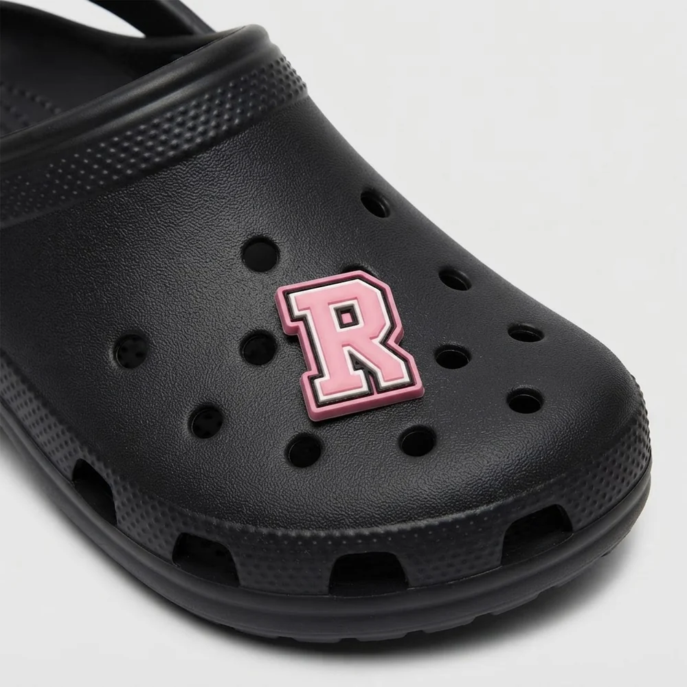 Jibbitz lettre R rose clipsé sur une Crocs