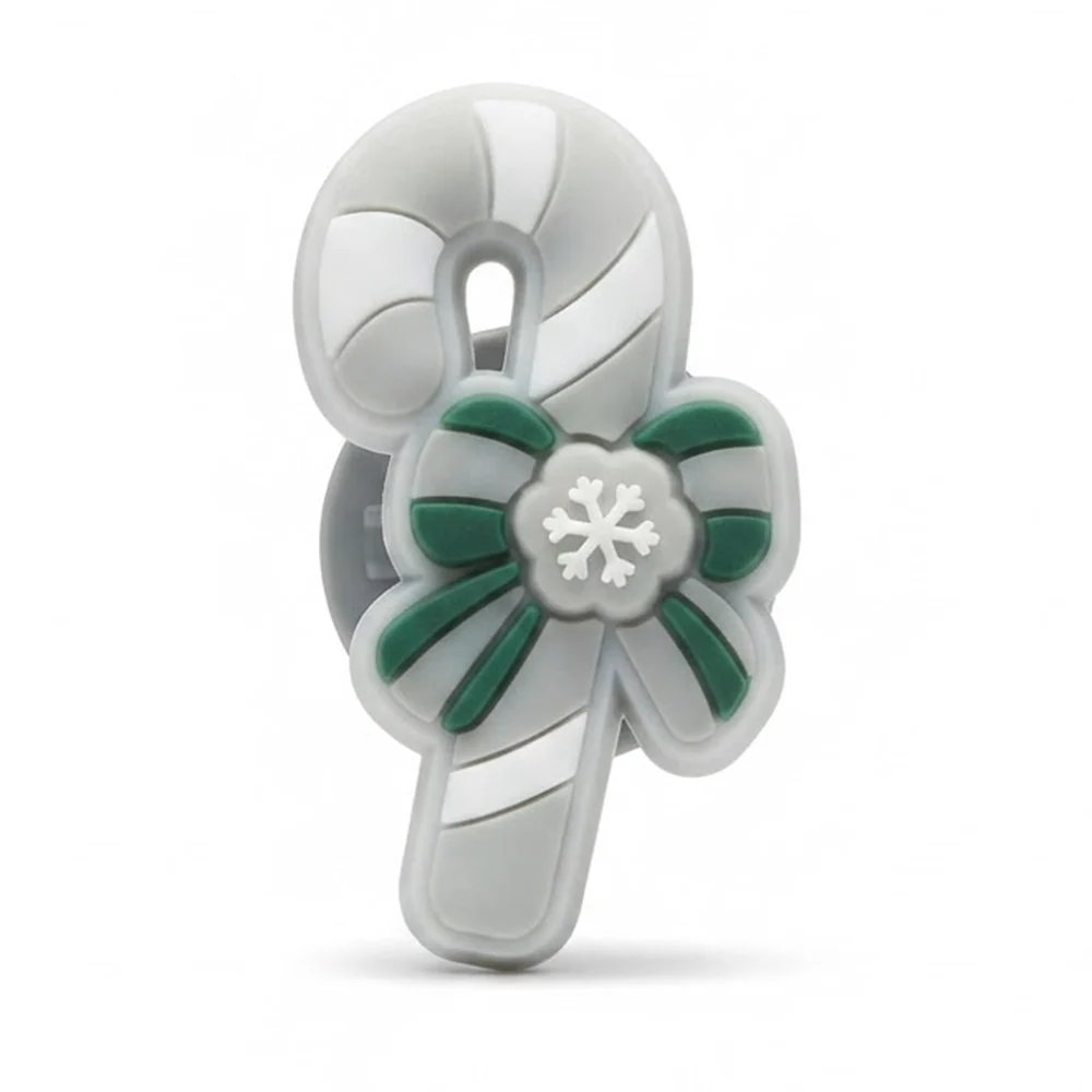 Jibbitz sucre d'orge rayé version fluo avec nœud vert et flocon blanc