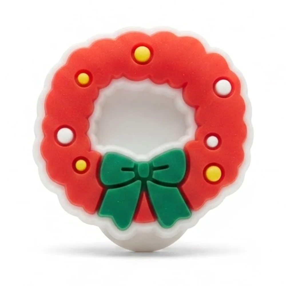 Jibbitz couronne de Noël rouge version fluo, boules jaunes et nœud vert